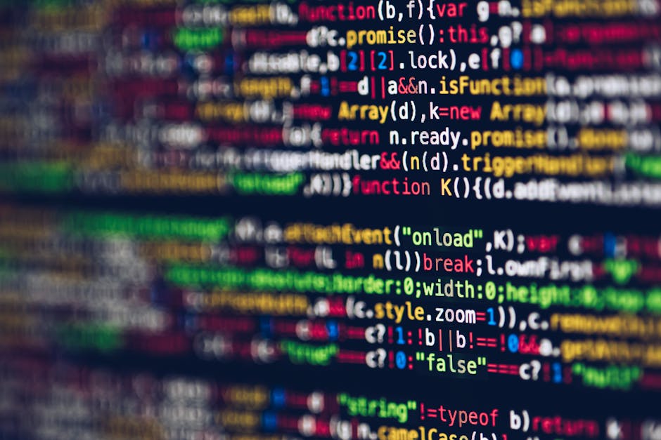 A close-up view of a computer screen displaying a dense scene of multi-colored programming code, predominantly featuring lines of text in various shades of green, red, yellow, blue, and white against 
